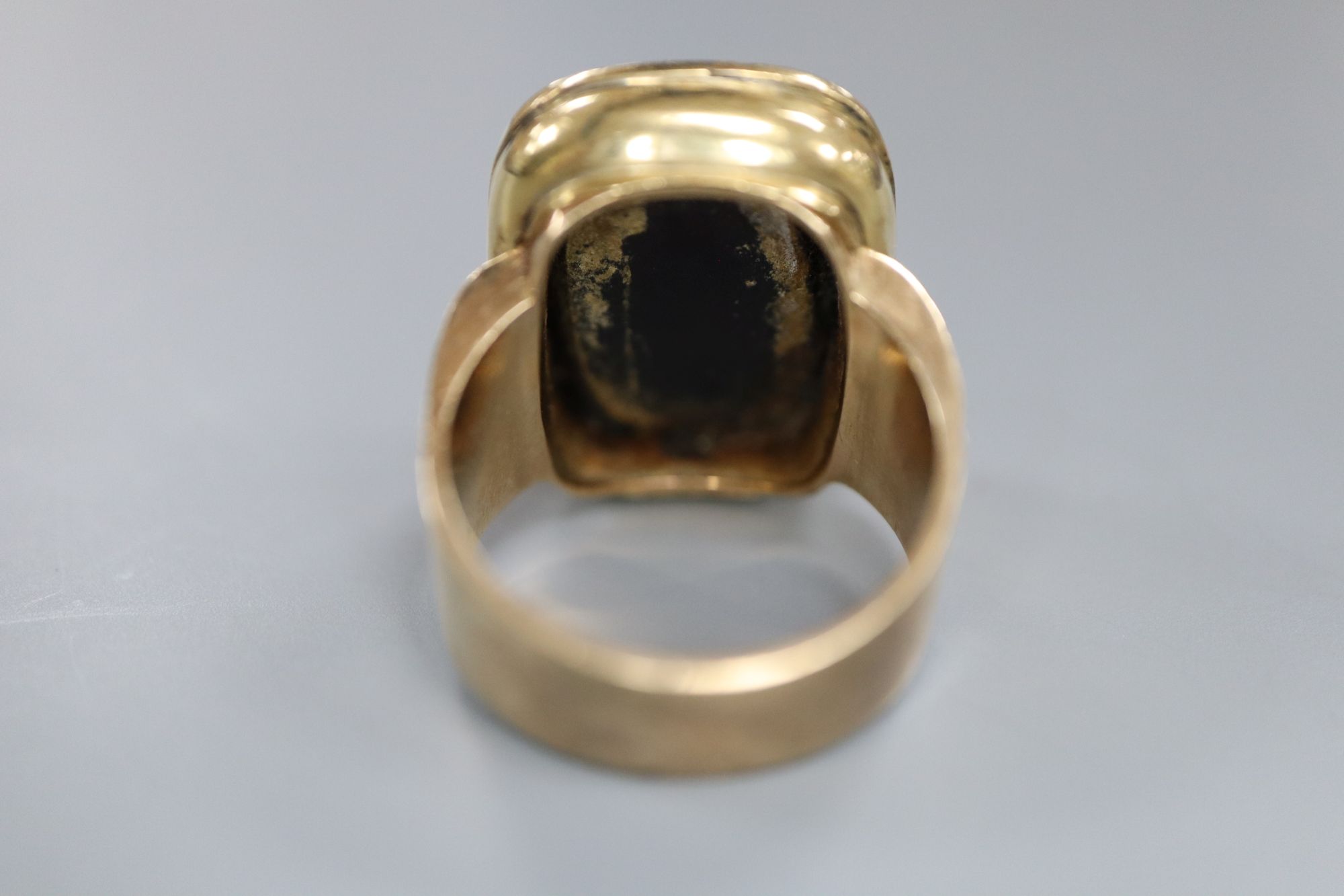 A 9ct and black onyx? intaglio ring, carved with the bust of a gentleman to sinister, size R/S, gross 16.2 grams.